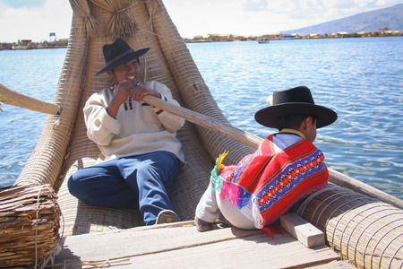 Puno, Peru, October.16. 2012: Local people - Peru, Uros floating village, Titikaka lake.のeditorial素材