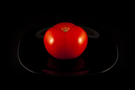 tomato on black plateの写真素材