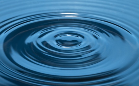 The circles in the blue liquid, formed from the burning droplets.の写真素材