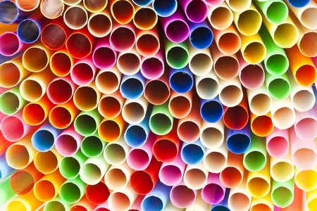 Colourful straws, red, green, blue, yellow, orange, pink  arranged side by side.の写真素材