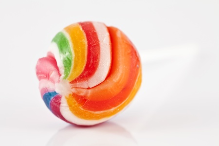 Round, sweet, colorful lollipops with white handle on a gray background.の写真素材