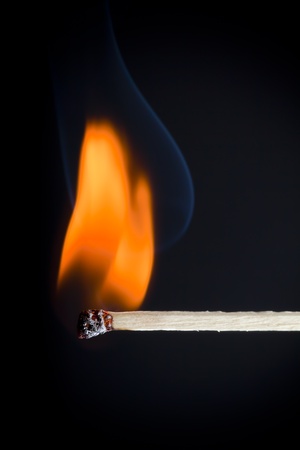 Red orange flames of wooden matches on a black background.の写真素材