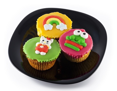 Three colorful Cupcakes on the black plate の写真素材