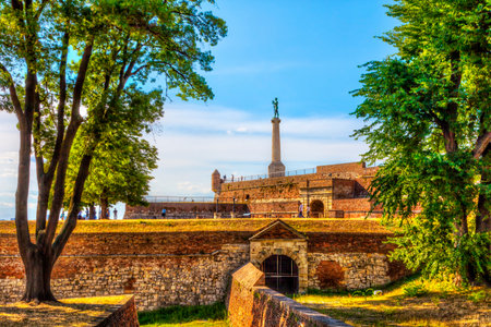 SERBIA, BELGRADE - JULY 26: Victor Monument on July 26, 2017 in Belgrade. Passage through the Kalemegdan Fortress, trees and Victor, HDR Image.のeditorial素材