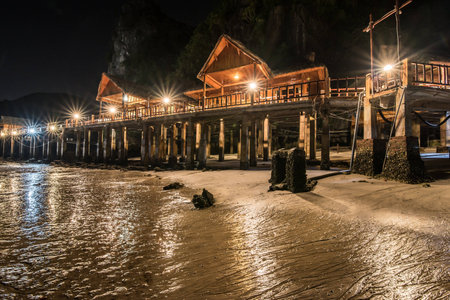 Romantic beach bungalows and lights at the nightの写真素材