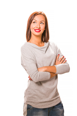 Brown hair beautiful woman with cross hands wearing grey shirt and jeans.の写真素材