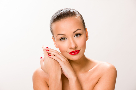 Brown sleek hair beautiful woman with hands close to face.の写真素材