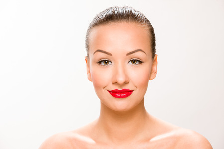 Brown sleek hair beautiful woman with with red lips looking at camera.の写真素材