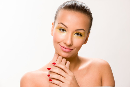 Brown sleek hair beautiful woman with hands close to face.の写真素材