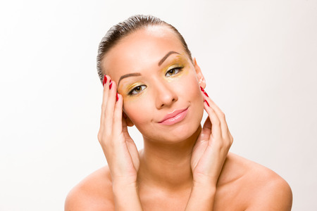 Brown sleek hair beautiful woman with hands close to face.の写真素材