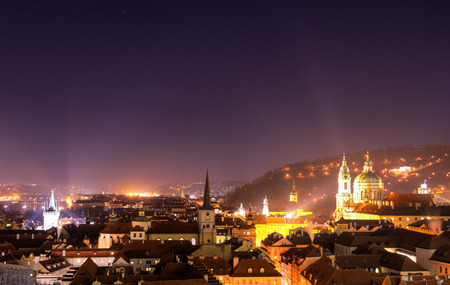 Lesser Town and Tower of St Nicholas Church during clear night. Typical red roofs of historical part of Prague, Czech republic.の写真素材