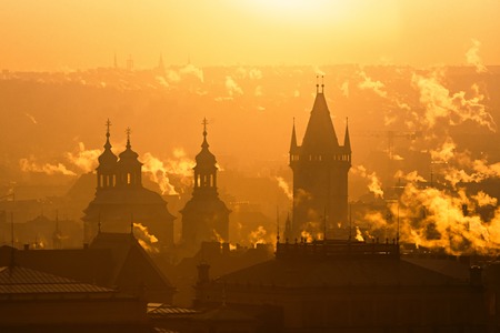 Prague foggy sunrise with historical architecture silhouette, Czech republic.の写真素材