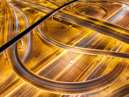 Extraordinary thoroughfare leading to Abu Dhabi during night rush hour near biggest skyscrapers....