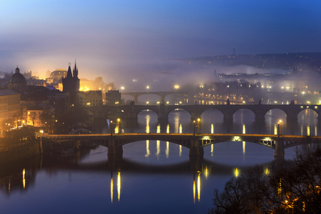 Amazing Charles bridge during foggy morning with several bridges, Prague, Czech republicの写真素材