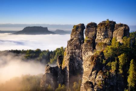 Rocky mountain view during autumn season. Foggy sunrise at Bastei, Saxon Switzerland, Germanyの写真素材