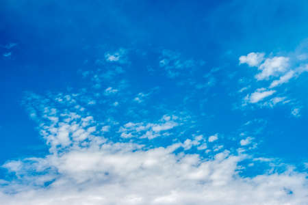 clear blue sky with tiny clouds forming into the larger formations