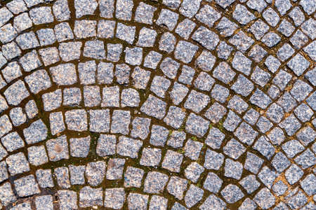 gray cobblestones sloppy arranged in a curve patternの写真素材