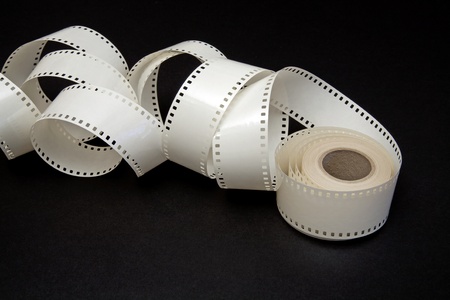 white film reel on a black backgroundの写真素材