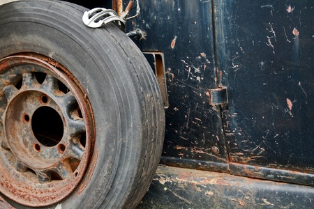 rusty wheel on the side of an old carの写真素材