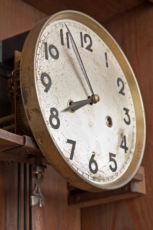 face of an antique clock indicating nearly eightの写真素材