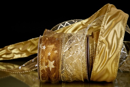 three decorative ribbons unrolling from the spools show its qualitiesの写真素材