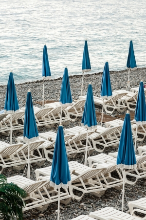umbrellas waiting for better weather at the seasideの写真素材