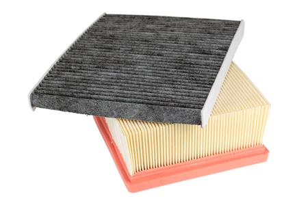 two air filters for different applications in the automotive industry. one cleans the air supplied to the engine and the other protects the passengers against pollenの写真素材