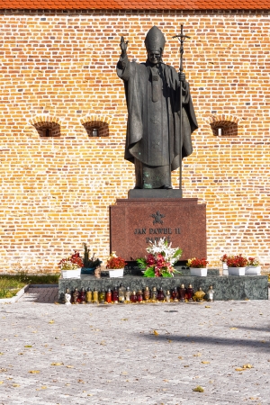 POLAND, LEZAJSK - SEPTEMBER 26: The walls of the basilica in Lezajsk and statue of Pope John Paul II on September 26, 2012. The sculpture is by Polish artist Marian Konieczny.のeditorial素材
