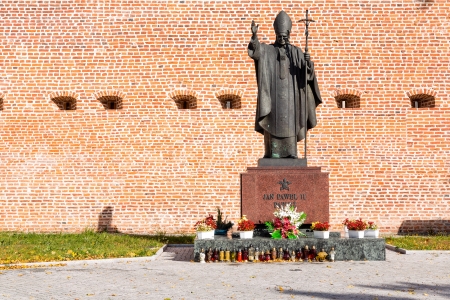 POLAND, LEZAJSK - SEPTEMBER 26: The walls of the basilica in Lezajsk and statue of Pope John Paul II on September 26, 2012. The sculpture is by Polish artist Marian Konieczny.のeditorial素材