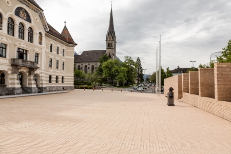 LIECHTENSTEIN, VADUZ - MAY 18: Completed in 1905 The Government building and built in 1873 St. Florian Cathedral in Vaduz on May 18, 2012.のeditorial素材