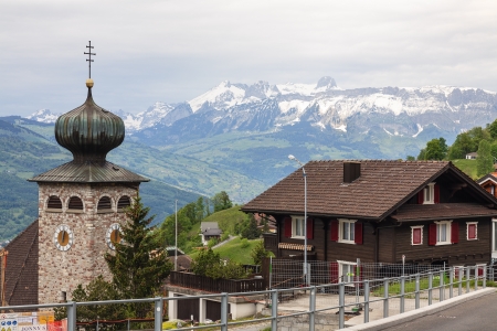 LIECHTENSTEIN, TRIESENBERG - MAY 18, 2012. The Bell Tower St. Joseph's Parish Church and dwelling house in Triesenberg, Liechtenstein on May 18, 2012. The Roman Catholic Church in Liechtenstein is under the spiritual leadership of the Pope and curia in Roのeditorial素材