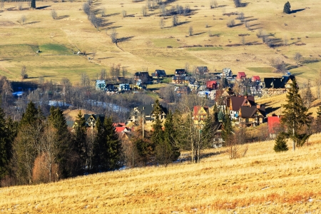 Residential buildings among the fields around Zakopane in Polandの写真素材