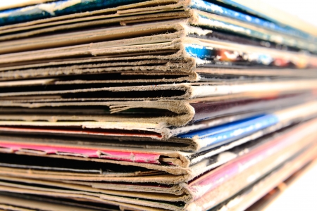 Stack of old vinyl records in traditional and colorful cardboard covers