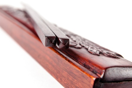 Chopsticks are shown on the ornate wooden box の写真素材