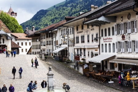 GRUYERE - MAY 25: Unidentified tourists overlooking the market and historic buildings of Alpine city with only about 1800 citizens (2008) in Gruyere in Switzerland on May 25, 2013のeditorial素材