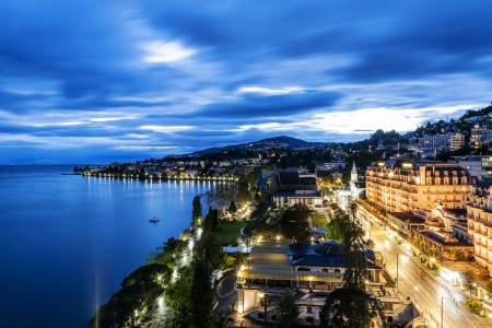 MONTREUX - MAY 19: Night view of Le Montreux Palace Hotel a five star luxury hotel built in 1906 and Montreux Music & Convention Centre (2m2c) and coastline in Montreux in Switzerland on May 19, 2013のeditorial素材