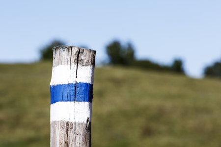 Hiking trail marked on a wooden pole along the wayの写真素材