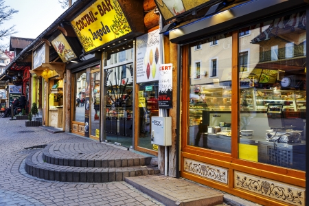 ZAKOPANE - NOVEMBER 16: Small restaurants along the Krupowki street, the main shopping area and pedestrian promenade in the city center in Zakopane in Poland on November 16, 2013のeditorial素材