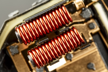 An electrical coil with iron core, detail of the control device used in the automotive industry shown up closeの写真素材