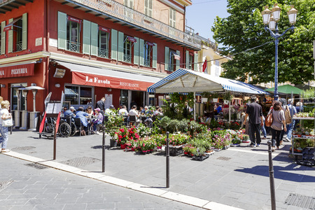 NICE, FRANCE - MAY 24, 2014  Cours Saleya, most famous City market, offers flowers and other products every day but Mondays it becomes an antiques market, on summer evenings, crafts and art marketのeditorial素材