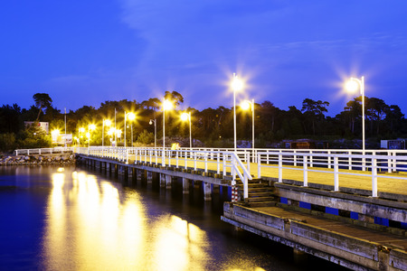 JURATA, POLAND - SEPTEMBER 11, 2014: Night view of Wooden Pier with a length of 320 meters, built in the 70s of the 20th century, located at the Baltic Sea coast at the waters of the Gulf of Puckのeditorial素材
