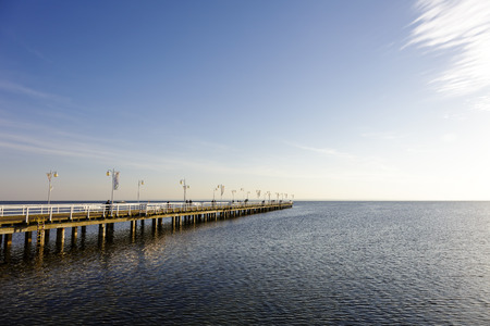 JURATA, POLAND - SEPTEMBER 06, 2014: Evening view of Wooden Pier with a length of 320 meters, built in the 70s of the 20th century, located at the Baltic Sea coast at the waters of the Gulf of Puckのeditorial素材