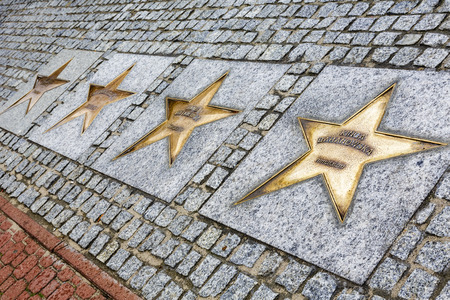 WLADYSLAWOWO, POLAND - SEPTEMBER 12, 2014: The Stars made of bronze with the names of sportsmen on the Avenue of the Stars of Sport, created in 2000 on the promenade leading from the city to the seaのeditorial素材