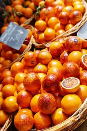 NICE, FRANCE - MAY 11, 2014: Oranges exposed for sale on Cours Saleya, most famous City market, offers fruits and various gifts, flowers also antiques and other productsのeditorial素材