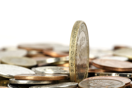 One coin set upright, towers over other