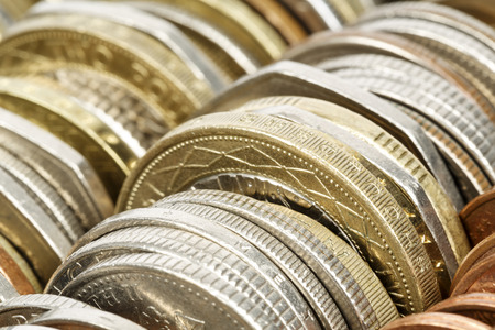 Different coins shown up close, forms the backdrop