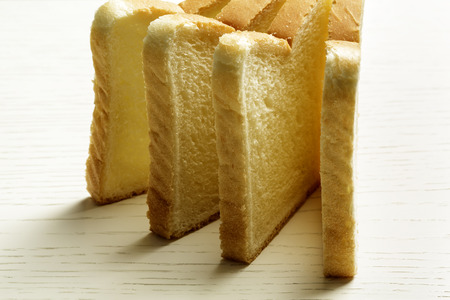 Sliced toast bread shown on a surface of white table
