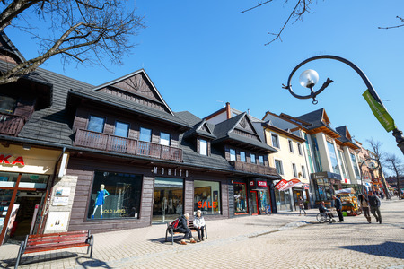 ZAKOPANE, POLAND - MARCH 09, 2015: Commercial premises located in wooden villa, built approx. 1910, at the main pedestrian street in the city named Krupowkiのeditorial素材