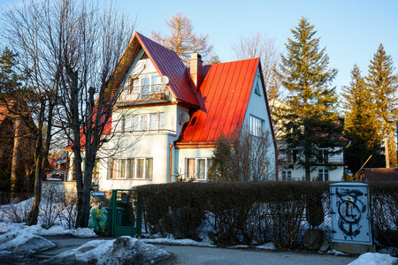 ZAKOPANE, POLAND - MARCH 08, 2015: Brick house situated in a residential area of the city, offers 11 beds for short-term tourist accommodationのeditorial素材