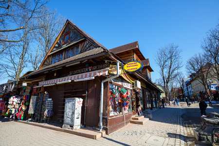 ZAKOPANE, POLAND - MARCH 10, 2015: Formerly residential building, nowadays commercial building, built of wood approx in 1900, located at Krupowki, the main pedestrian street in the cityのeditorial素材